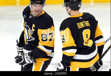 Michael Bunting (8 ans), l'aile gauche des Penguins de Pittsburgh, célèbre son but avec le centre des Penguins de Pittsburgh Sidney Crosby (87 ans) lors de la deuxième période contre les Islanders de New York au PPG Paints Arena de Pittsburgh le dimanche 29 décembre 2024. Le centre des Penguins de Pittsburgh Sidney Crosby (87) a enregistré sa 1034e aide, dépassant Mario Lemieux. Photo par Archie Carpenter/UPI. Banque D'Images