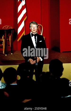 Le président des États-Unis Jimmy carter fait des remarques alors que lui et la première dame Rosalynn carter organisent un dîner en l'honneur des gouverneurs des États et de leurs conjoints dans la salle est de la Maison Blanche à Washington, DC le mardi 1er mars 1977. La scène derrière le Président est aménagée pour une représentation de sélections de la comédie musicale « Annie ». Photo de Arnie Sachs/CNP/ABACAPRESS. COM Credit : Abaca Press/Alamy Live News Banque D'Images