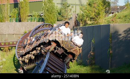 Les jeunes s’amusent sur la courbe inclinée sur les montagnes russes de lancement intenses «Toutatis» du fabricant «Intamin» dans le parc à thème «Astérix» Banque D'Images