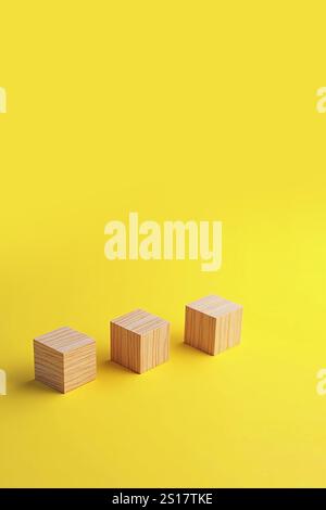 Dernière pièce bloc de cube en bois dans la main mettant sur des puzzles en bois empilant l'arrangement terminé isolé sur fond jaune. Banque D'Images