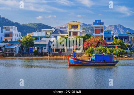 Il y a beaucoup de bateaux de pêche traditionnels vietnamiens et de navires dans la baie sur la rivière au port de pêche de Vinh Truong à Nha Trang, Vietnam Banque D'Images