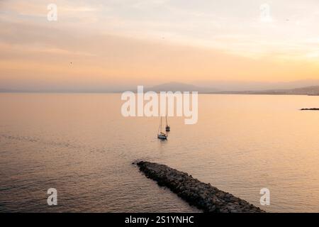 Vue de deux voiliers dans la baie nord de Ceuta, en face de la plage de chorrillo, au coucher du soleil. Banque D'Images