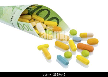 Comprimés et un billet de cent euros photo symbolique : coûts pour les médicaments et les médicaments de l'industrie pharmaceutique Autriche Banque D'Images