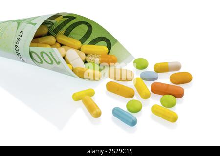 Comprimés et un billet de cent euros photo symbolique : coûts pour les médicaments et les médicaments de l'industrie pharmaceutique Autriche Banque D'Images