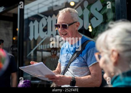 Un guide touristique de Meetup parlant au groupe dans une rue animée de Camden. Banque D'Images
