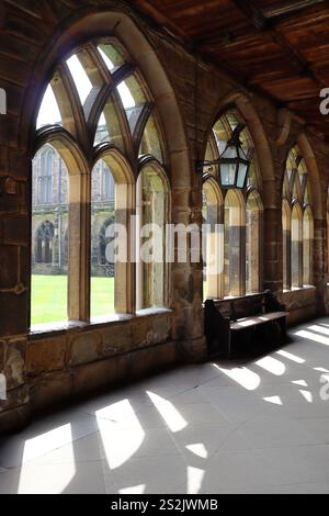 Le jeu de lumière et d'ombres projeté par les fenêtres cintrées dans le cloître intérieur de la cathédrale de Durham. Angleterre, Royaume-Uni. Banque D'Images