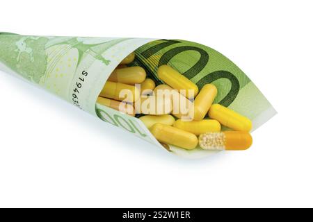 Comprimés et un billet de cent euros photo symbolique : coûts pour les médicaments et les médicaments de l'industrie pharmaceutique Autriche Banque D'Images