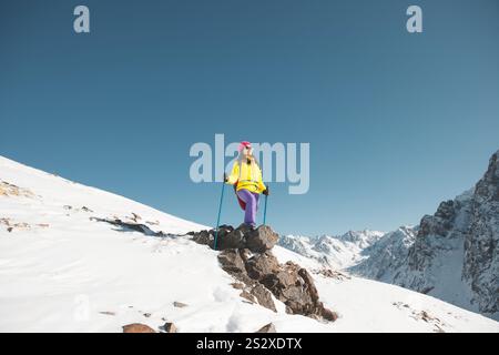 Femme debout au sommet de la montagne enneigée Banque D'Images