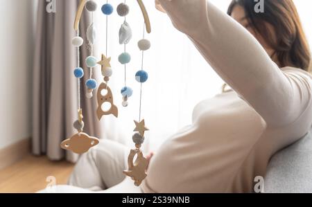 Femme asiatique enceinte se préparant pour la maternité préparant et planifiant des vêtements de bébé pour le nouveau bébé de grossesse emballage pour la maternité Banque D'Images