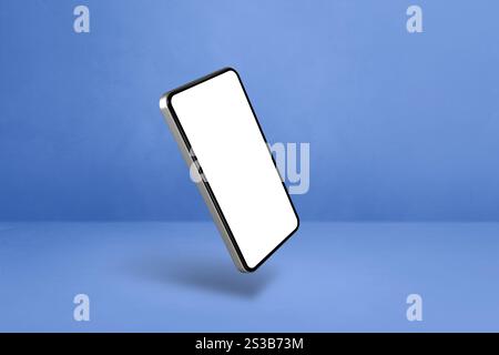 Smartphone vierge flottant sur un fond bleu. Illustration isolée 3D. Modèle horizontal. Smartphone flottant isolé sur bleu. Horizontal Banque D'Images