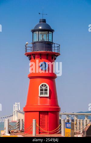 Le phare de Changshanwei est situé sur l'île de Nan'ao à Shantou, Guangdong en Chine. L'arrière-plan est le pont Shantou Nan'ao Banque D'Images