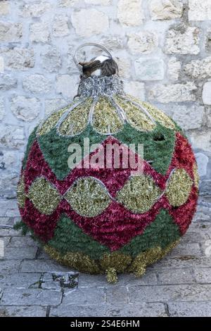 Décoration de Noël, chat dormant sur une grande boule de sapin de Noël, Kotor, Monténégro, Europe Banque D'Images