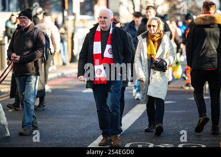 Fan du Brentford FC se rendant au stade en FA Cup, Brentford FC VS Plymouth Argyle 11/01/25 Banque D'Images