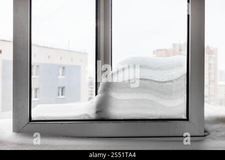 Snowdrift entre les vitres des fenêtres de la maison d'habitation dans la ville de Moscou en hiver Banque D'Images