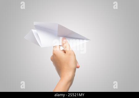 Avion de Papier Dart main femme isolé sur fond blanc. Banque D'Images