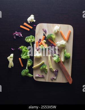 Avoir un mélange de légumes carottes, brocoli, chou-fleur, le chou, la laitue pourpre sur la planche à découper avec couteau - clean food concept Banque D'Images