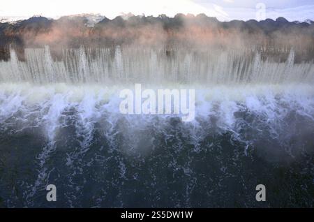 Barrage pour réguler le niveau d'eau dans la rivière. Chute d'eau monochrome avec de fortes éclats. Chute d'eau avec de fortes rafales Banque D'Images