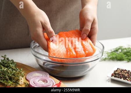 Femme avec filet de saumon et sauce soja à la table grise, gros plan Banque D'Images