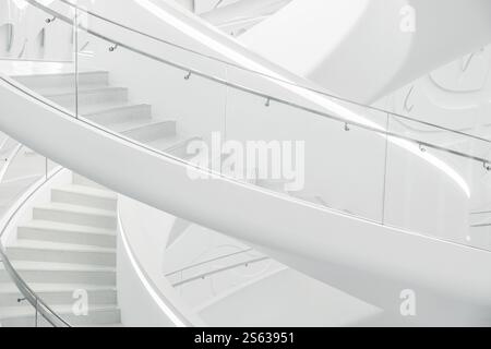 Escalier en colimaçon blanc minimaliste avec des courbes lisses et des motifs géométriques dans le Musée du futur, vue de dessous. Design intérieur moderne Banque D'Images