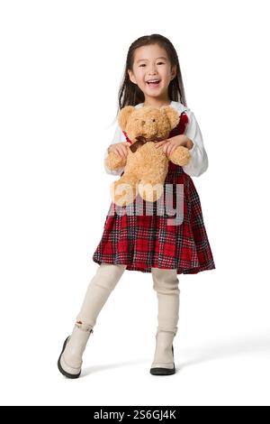 Fille heureuse tenant un ours jouet Banque D'Images