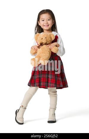 Fille heureuse tenant un ours jouet Banque D'Images