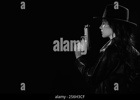 Silhouette d'une détective féminine dans un manteau et un chapeau avec un pistolet dans ses mains. Un livre drame noir portrait dans le style des détectives des années 1950 Banque D'Images