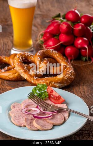 Salade de saucisses bavaroises sur bois sombre Banque D'Images