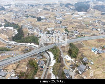 Prise de vue aérienne d'un paysage hivernal enneigé de la ville d'Iida, préfecture de Nagano, à l'aide d'un drone. Banque D'Images