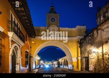 Arco de Santa Catalina la nuit, avec Volcán de Agua en arrière-plan. Antiqua, Guatemala, Amérique centrale. Banque D'Images