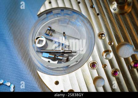 Crafting precision in timekeeping with exquisite clock mechanism spare parts arranged meticulously on a gleaming main body Banque D'Images