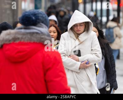 Toronto, Canada. 21 janvier 2025. Les gens bravent le froid en marchant dans une rue de Toronto, Canada, le 21 janvier 2025. Environnement Canada a émis un avertissement de froid extrême pour la ville de Toronto mardi, avec des valeurs de refroidissement éolien proches de moins 30 degrés Celsius à aussi bas que moins 35 degrés Celsius. Crédit : Zou Zheng/Xinhua/Alamy Live News Banque D'Images
