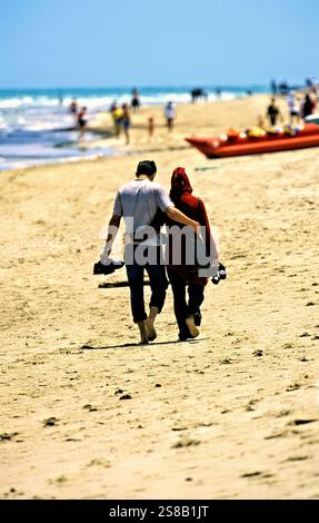Couple marchant sur une plage de sable, Djerba, Tunisie Banque D'Images