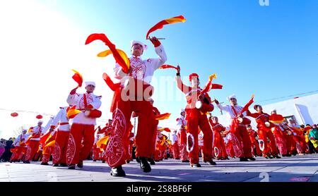 Zhangye, Chine. 22 janvier 2025. Les amateurs de patrimoine culturel immatériel jouent le ''Happy Waist Drum'' pour les touristes sur la place culturelle du village de Zhenjiang, ville de Heiquan, comté de Gaotai, ville de Zhangye, dans la province du Gansu du Nord-Ouest de la Chine, le 21 janvier 2025. (Photo de Costfoto/NurPhoto) crédit : NurPhoto SRL/Alamy Live News Banque D'Images