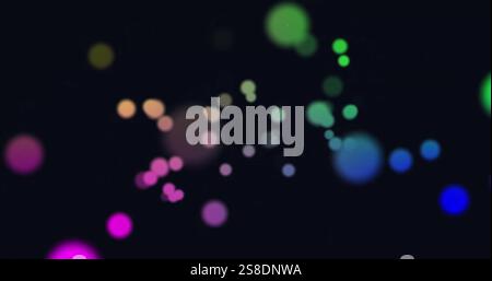 Image de taches lumineuses colorées sur fond noir Banque D'Images