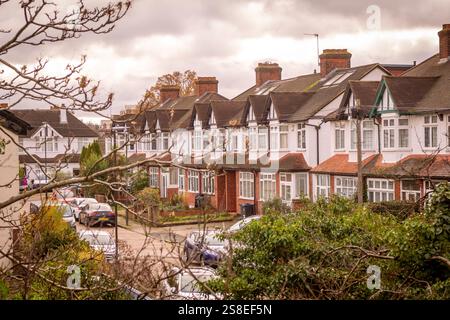 LONDRES- rangée de maisons mitoyennes avec baies vitrées et parking dans la rue dans la région de Morden au sud-ouest de Londres Banque D'Images