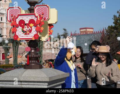 Pékin, Chine. 22 janvier 2025. Les touristes prennent des selfies au Shanghai Disney Resort de Shanghai de l'est de la Chine, 22 janvier 2025. Alors que le nouvel an chinois 2025 tombera le 29 janvier, l’excitation est palpable partout en Chine. Les Chinois se plongent dans les coutumes traditionnelles et participent aux festivités. Le nouvel an chinois, ou la fête du printemps, tombe mercredi prochain, marquant le début de l'année du serpent. Crédit : Liu Ying/Xinhua/Alamy Live News Banque D'Images