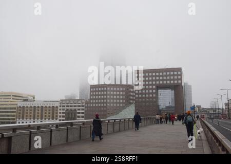 Londres, Royaume-Uni. 27 décembre 2024. Les gens marchent le long du London Bridge en passant devant un bâtiment Shard obsédé tandis que le brouillard descend sur la capitale. Crédit : Vuk Valcic/Alamy Banque D'Images