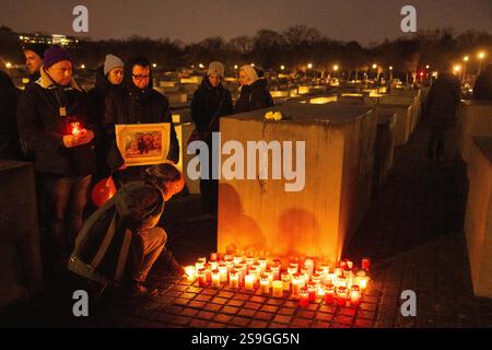 26 janvier 2025, Berlin : une femme pose une bougie au Mémorial des Juifs assassinés d'Europe pour marquer la Journée internationale de commémoration des victimes de l'Holocauste le 27 janvier. Photo : Christophe Gateau/dpa Banque D'Images