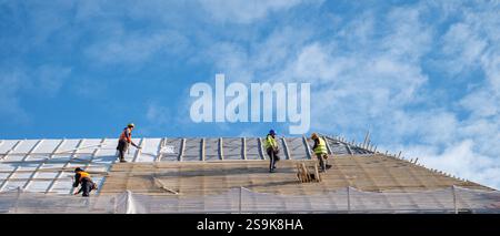 Sibiu, Roumanie - 12 novembre 2024. les ouvriers installent des panneaux photovoltaïques sur le toit Banque D'Images