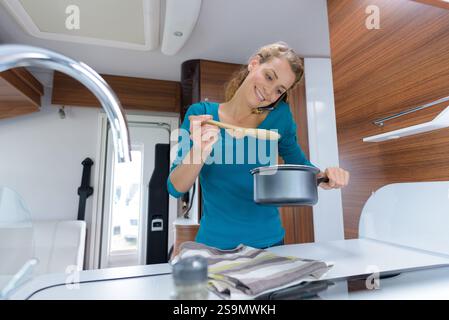 femme cuisinant dans le camping-car Banque D'Images