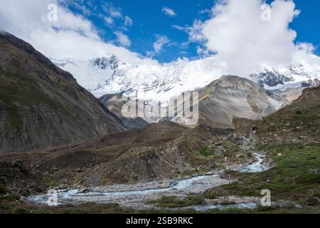 Paysage à couper le souffle représentant des sommets enneigés de l'Himalaya sous un ciel bleu vif, avec la rivière Marsyangdi à proximité du camp de base de Tilicho. Banque D'Images