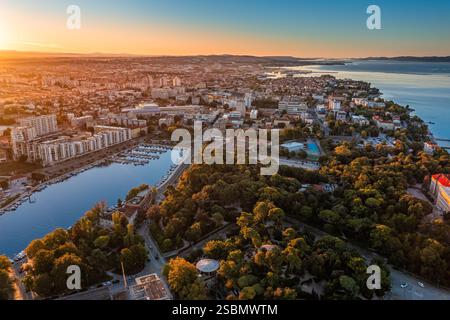 Zadar, Croatie - vue aérienne de la vieille ville de Zadar avec le parc de Vladimir Nazor, yacht marina et lever de soleil doré le matin d'été avec bl clair Banque D'Images