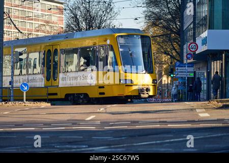 Baden-Württemberg, Stuttgart, Allemagne - 5 février 2025 : un tramway jaune SSB Stuttgarter Straßenbahnen AG traverse un carrefour urbain à Stuttgart. Les piétons, les panneaux de signalisation et les feux de circulation peuvent être vus en arrière-plan, régulant le flux des transports publics. *** Eine gelbe Straßenbahn der SSB Stuttgarter Straßenbahnen AG fährt durch eine Städtische Kreuzung, Stuttgart. IM Hintergrund sind Fußgänger, Verkehrsschilder und Ampeln zu sehen, die den Verkehrsfluss im öffentlichen Nahverkehr regeln. Banque D'Images