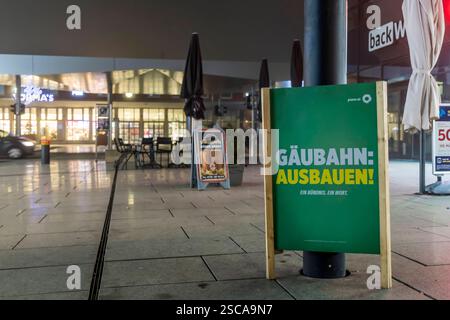 Wahlplakat zur Bundestagswahl 2025 vor dem Bahnhof in Singen. Die Partei DIE Grünen fordern einen Ausbau der Gäubahn, die vom Hauptbahnhof Stuttgart nach Zürich führt. //05.02.2025 : Singen, Bade-Württemberg, Allemagne. *** Affiche électorale pour l'élection du Bundestag de 2025 devant la gare de Singen le Parti vert réclame une extension du Gäubahn, qui relie la gare centrale de Stuttgart à Zurich 05 02 2025 Singen, Baden Württemberg, Allemagne Banque D'Images