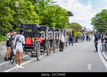 Kyoto, Japon - 05. 08. 2024 : Une rangée de pousse-pousse sur le bord de la route à Arashiyama. Attraction touristique en pousse-pousse. Banque D'Images