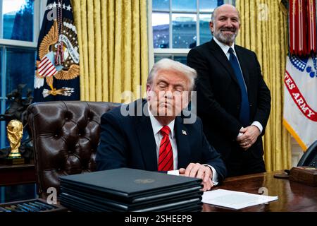 Washington, États-Unis. 10 février 2025. Le président AMÉRICAIN Donald Trump, rejoint par Howard Lutnick, président-directeur général de Cantor Fitzgerald LP et secrétaire américain au commerce nommé pour le président américain Donald Trump, lors d’une signature d’ordre exécutif dans le bureau ovale de la Maison Blanche à Washington, DC, États-Unis, le lundi 10 février, 2025. Trump a ordonné un droit de douane de 25% sur les importations d'acier et d'aluminium, intensifiant ses efforts pour protéger les industries américaines politiquement importantes avec des taxes frappant certains des alliés les plus proches du pays. Photographe : Al Drago/Pool/Sipa USA crédit : Sipa USA/Alamy Live News Banque D'Images