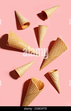 Mise en page créative de cônes de crème glacée sur fond pastel rose, vue de dessus, espace de copie. Concept de nourriture de dessert d'été sucré. Banque D'Images