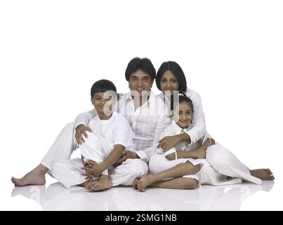 Famille indienne sud-asiatique avec père mère fils et fille assis appréciant et regardant la caméra MR . 698, 699, 700, 701 Banque D'Images