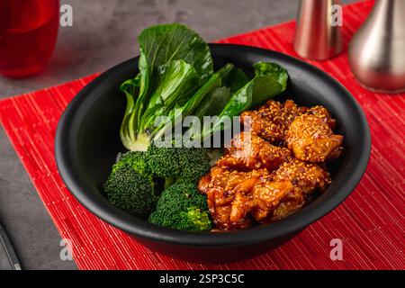 Bol de poulet Teriyaki avec brocoli et bok choy sur table en pierre grise Banque D'Images