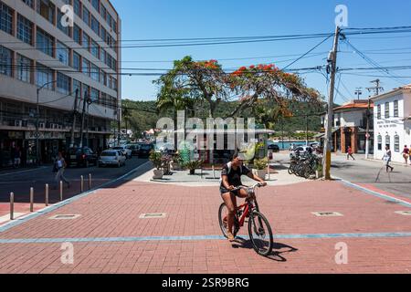 Cycliste à travers la zone piétonne entre Porto Rocha et les places Dom Pedro II près du canal Itajuru dans le quartier Centro sous le ciel de l'après-midi d'été. Banque D'Images